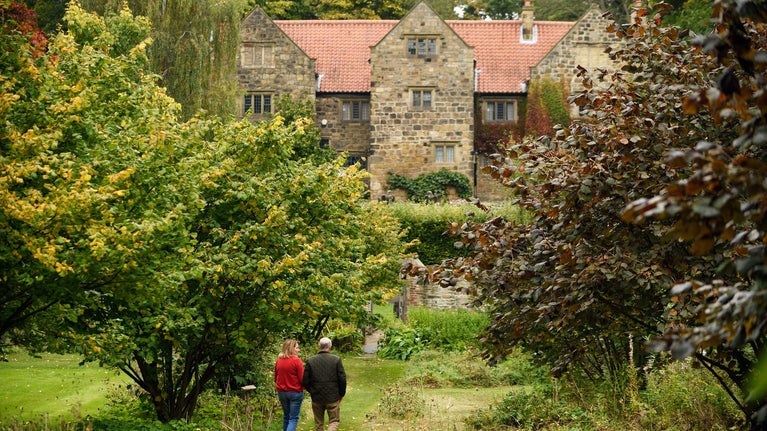 Visitors in the Orchard during autumn at Washington Old Hall, Tyne & Wear